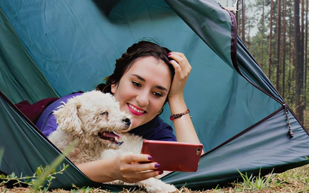 a woman and a dog in a tent